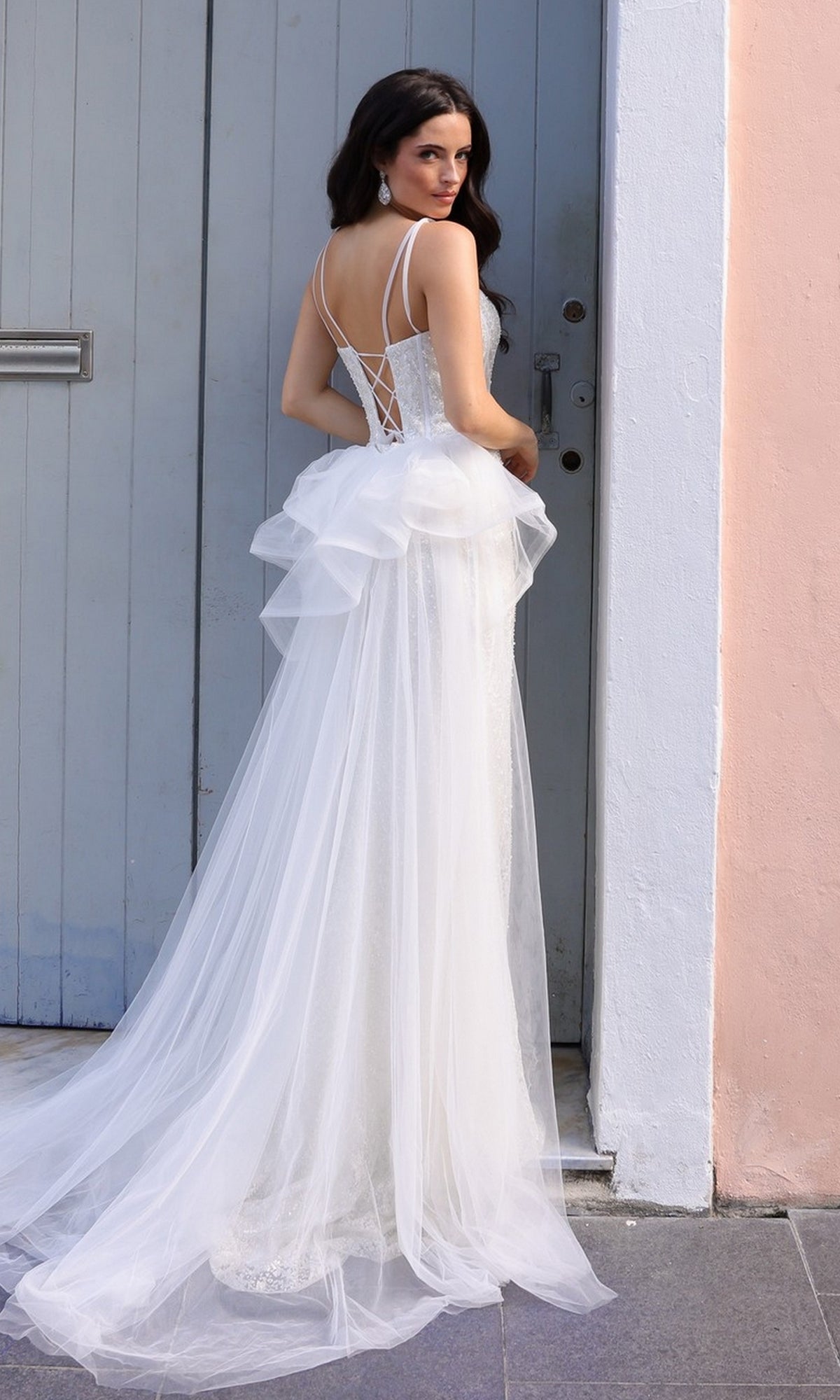 A woman wearing the Glitter-Print Long Prom Dress with Overskirt Y1475 in white.